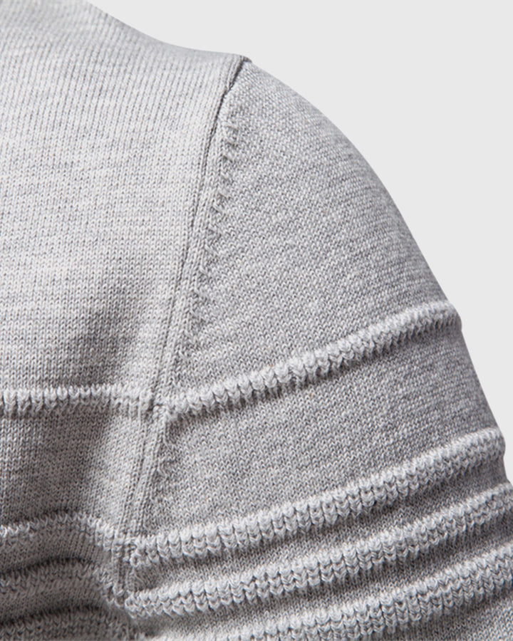 Detail of the hemline on a men's everyday textured crew neck sweater