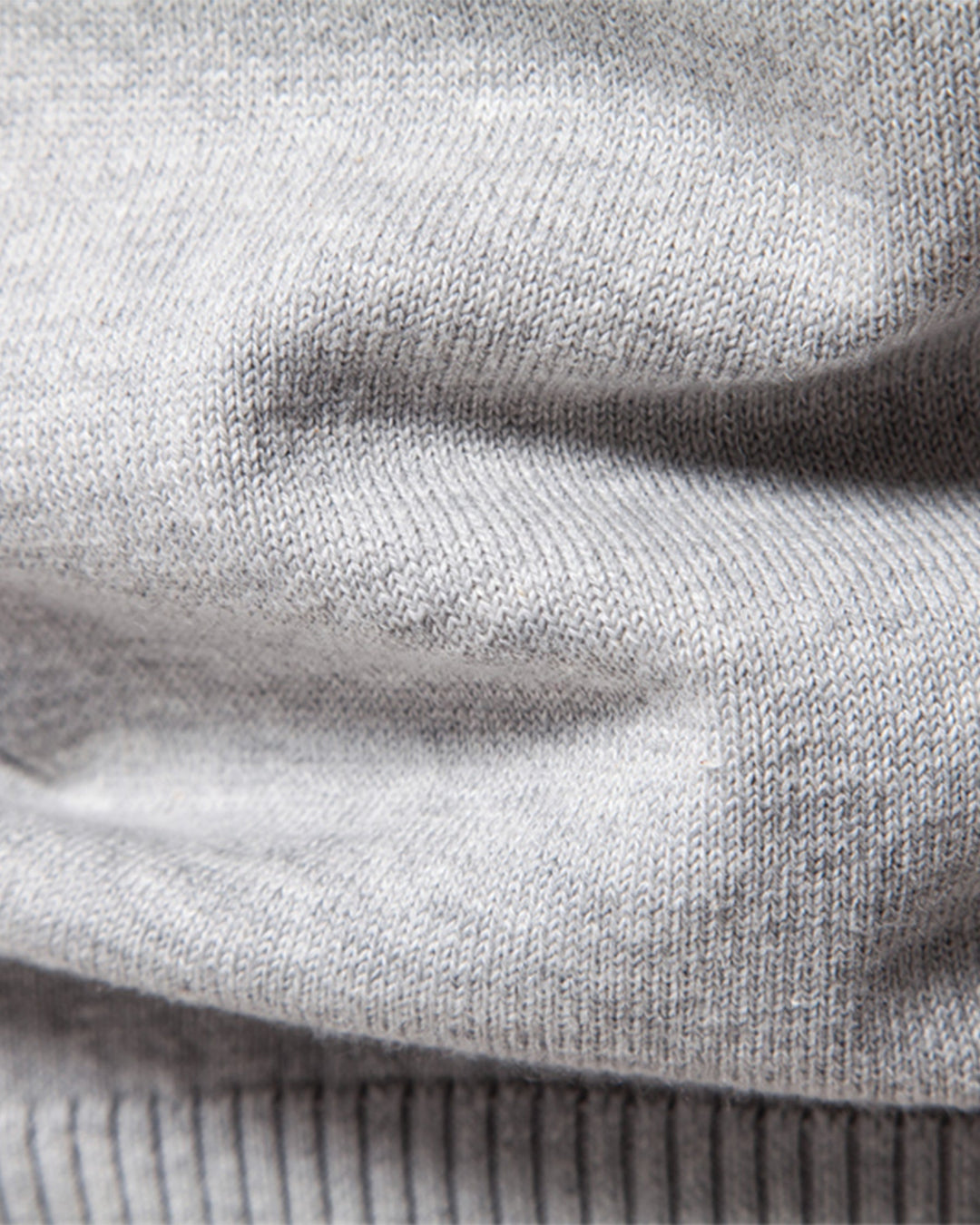 Flat lay of a men's textured crew neck sweater, ready for shipping