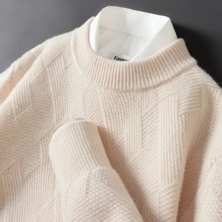 Detail shot of the fabric of a men's cotton blend sweater, highlighting the intricate textured knit.