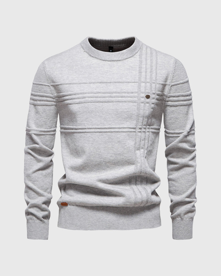 Studio shot of a folded men's premium knit long sleeve crew neck sweater