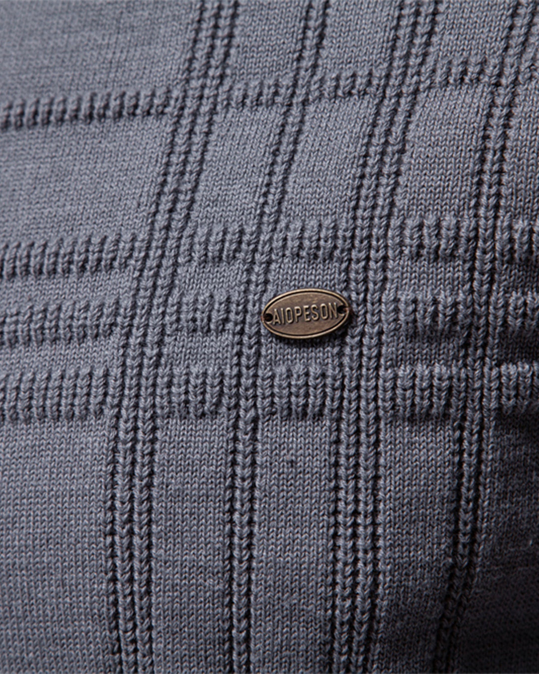 Detail of the ribbed collar on a stylish men's textured crew neck sweater