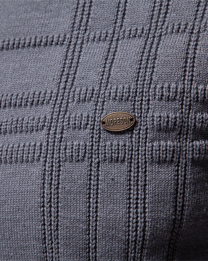 Detail of the ribbed collar on a stylish men's textured crew neck sweater