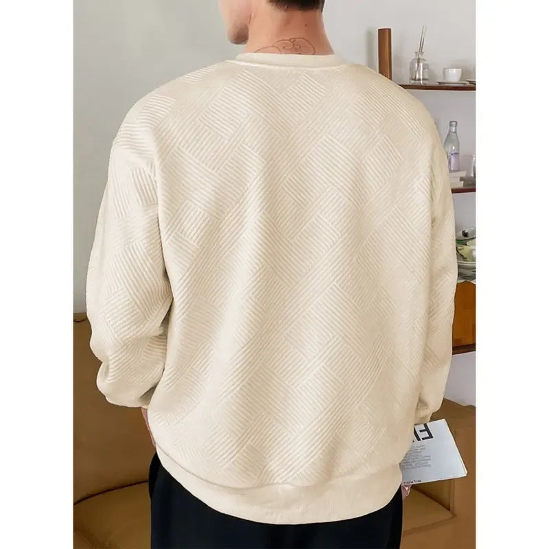 Close-up of a men's brown textured knit sweater, highlighting the soft cotton blend.
