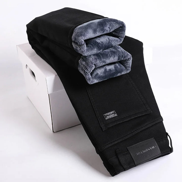Lifestyle shot of men's thermal lined denim jeans, styled casually for cold weather. Men's apparel.