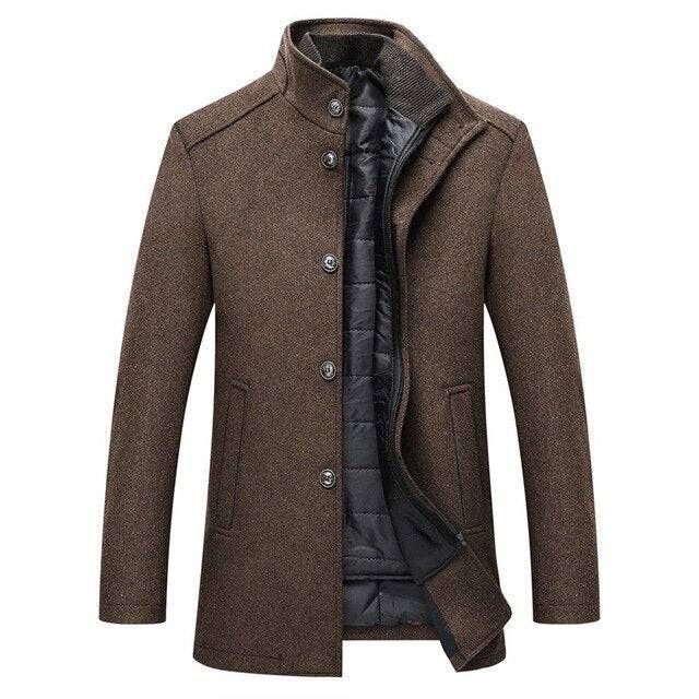 Side profile of a man wearing a thick wool single-breasted coat, showcasing its warm, structured fit.