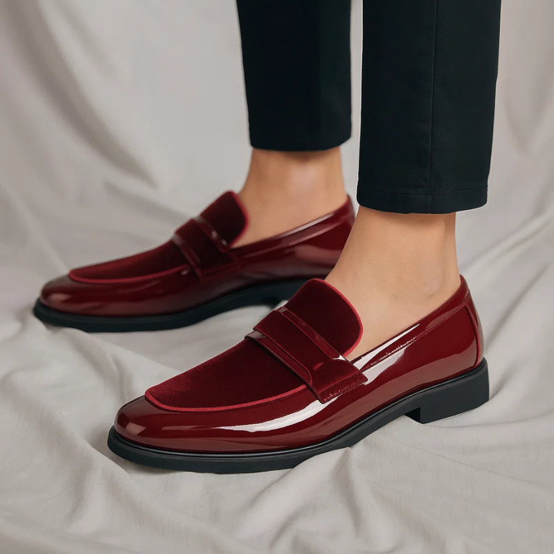 Overhead shot of classic men's black penny loafers, highlighting the signature penny slot and refined casual style.