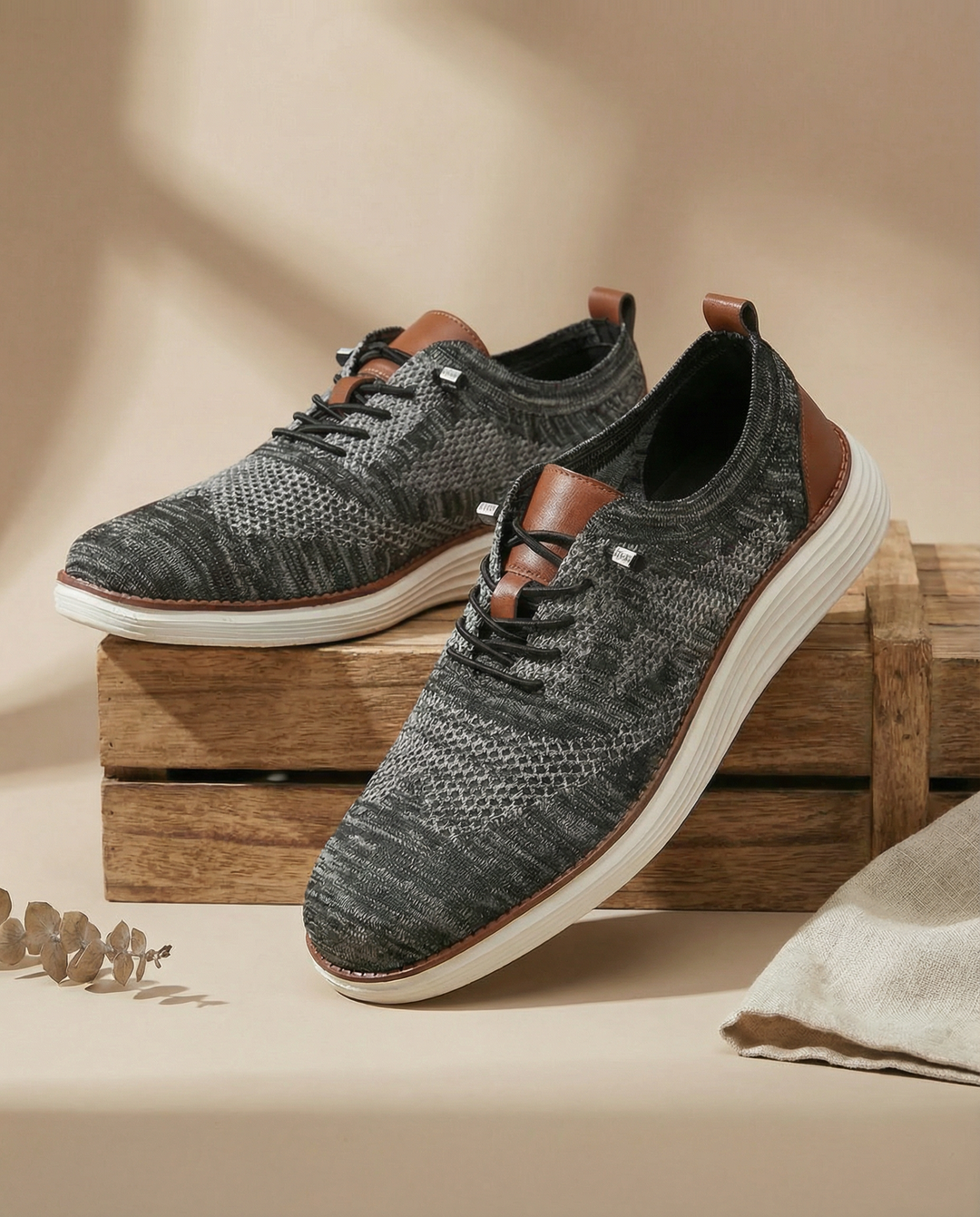 Close-up of men's knit sneakers, showcasing the detailed breathable fabric and comfortable design.