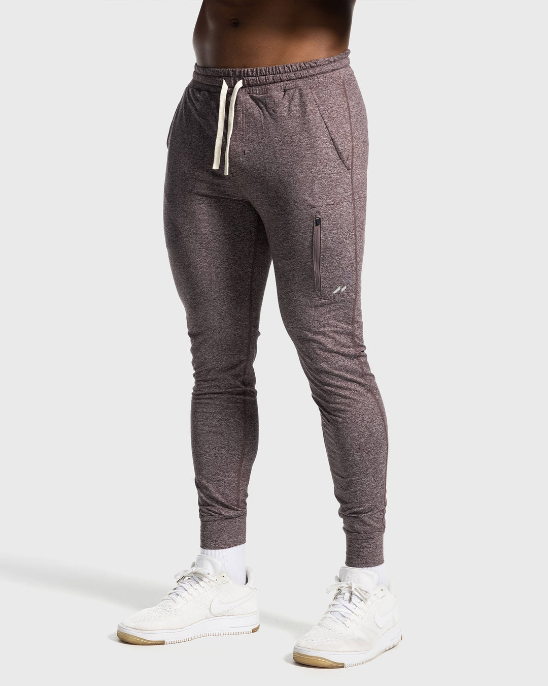 Full body shot of Man standing in Men's Valencia Joggers, showing complete tapered fit