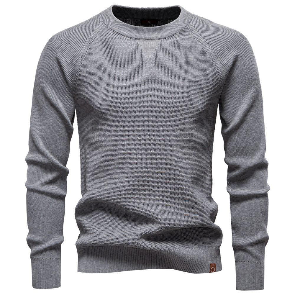 Hanger with a men's grey waffle knit long sleeve sweater, emphasizing its knitwear quality.