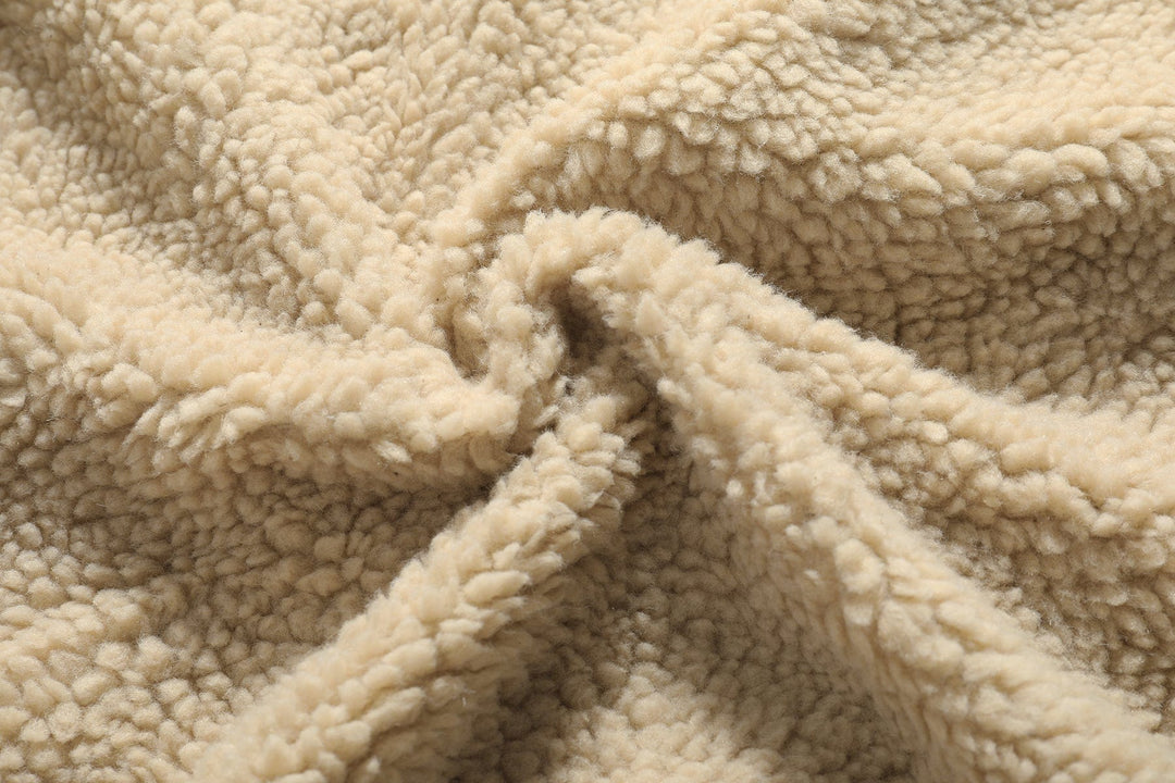 Folded men's vintage bomber jacket, showing full sherpa interior, ready for travel or storage.