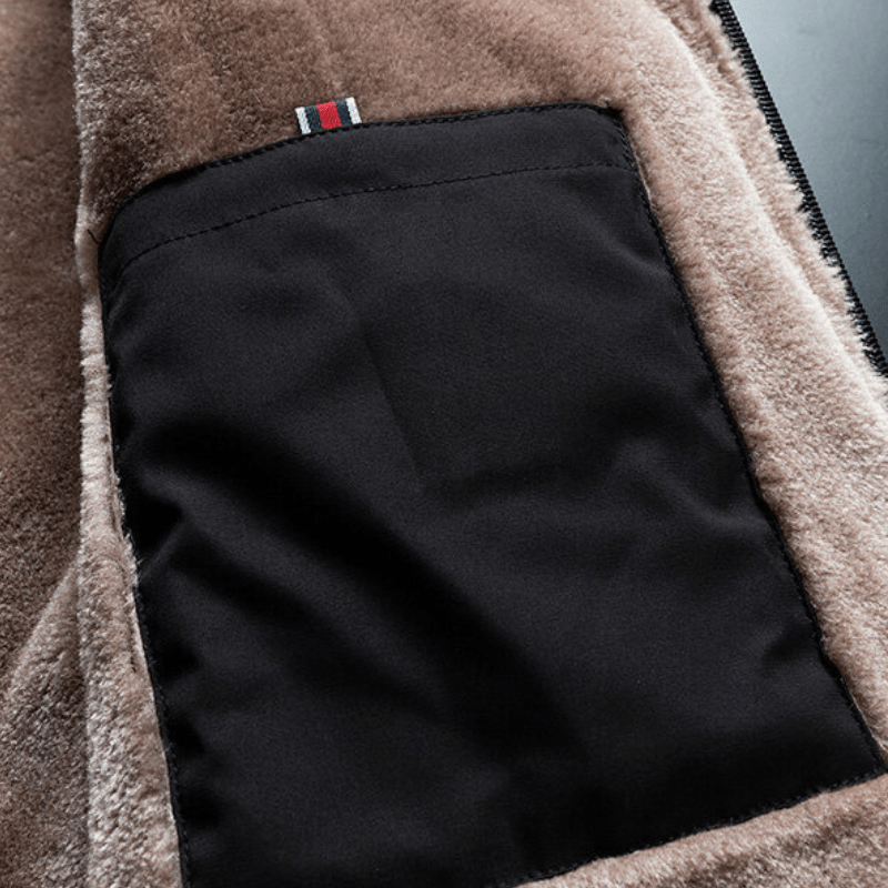 Detail of a men's black winter jacket showing the warm fluffy lining and polyester material