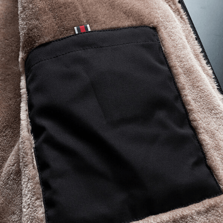 Detail of a men's black winter jacket showing the warm fluffy lining and polyester material