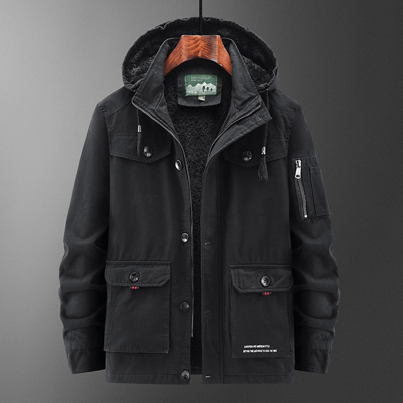 Man wearing a stylish men's winter parka coat with detachable hood in a snowy outdoor setting