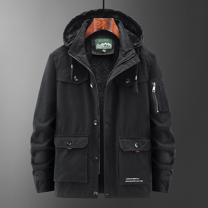 Man wearing a stylish men's winter parka coat with detachable hood in a snowy outdoor setting