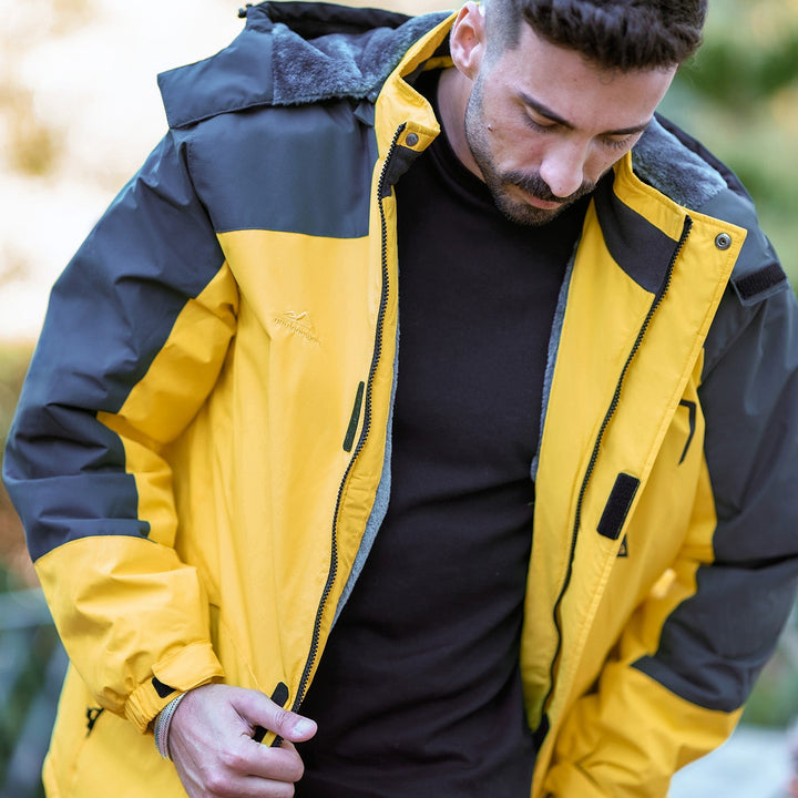 Chest pocket detail on men's red ski jacket, waterproof zipper.