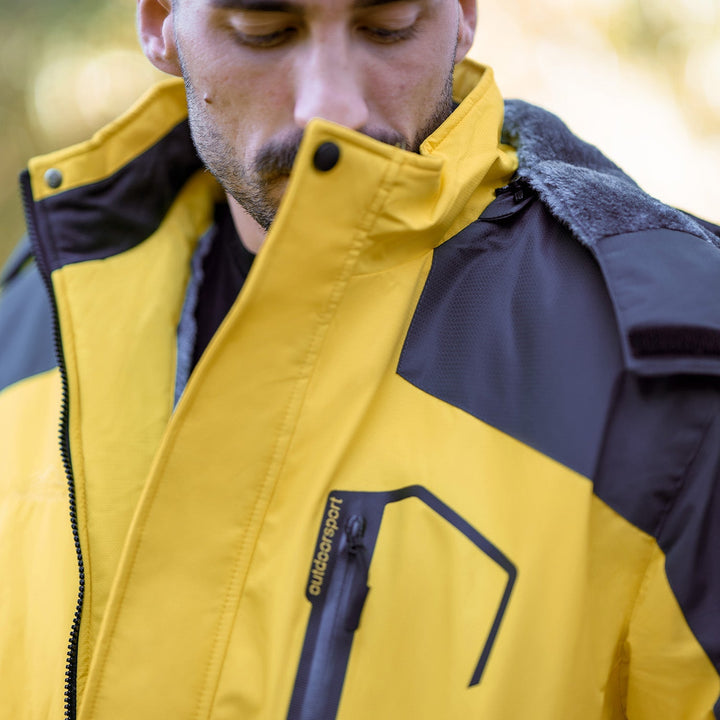 Close-up of green men's ski jacket material, illustrating windproof properties.