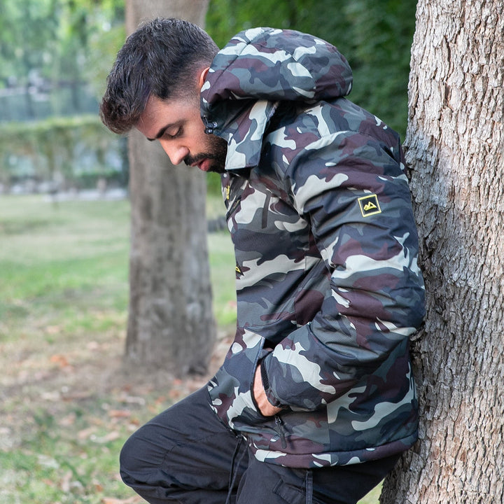 Ski jacket, men's waterproof windproof, being packed into a backpack.