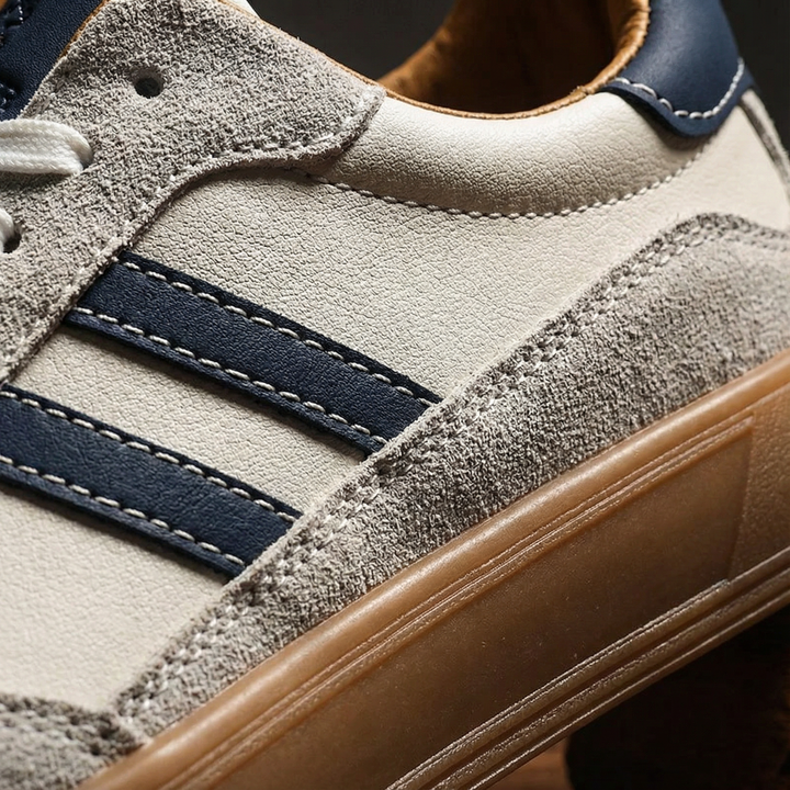 Men's white everyday comfort trainers, combining a leather upper with mesh panels and a sturdy gum sole.