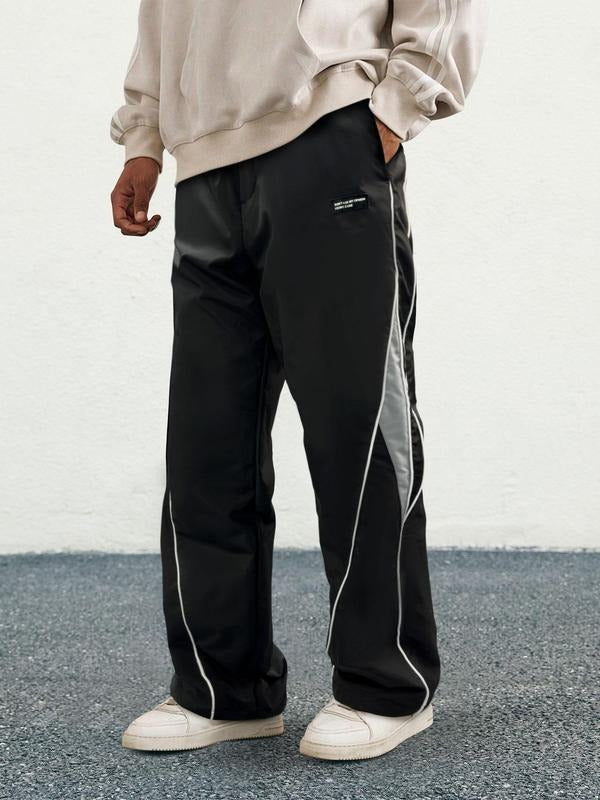 Men's Woven Performance Track Pants in black, showing a comfortable, relaxed fit for athletic activities.
