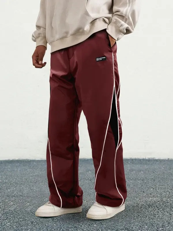 Close-up of the fabric on men's woven performance track pants, highlighting the polyester material.
