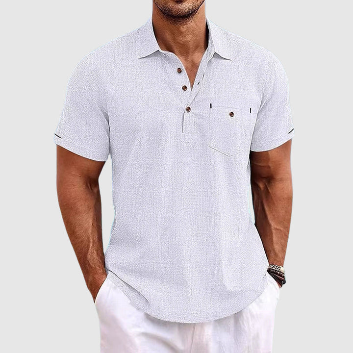 "Men's textured polo shirt with chest pocket, short sleeves, turn-down collar, and relaxed fit for warm-weather comfort."