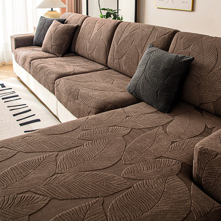 Jacquard stretch sofa cover with modern leaf pattern. Waterproof, anti-scratch, easy-clean protector for sofas.