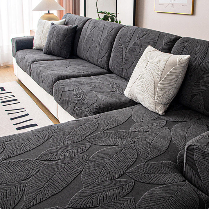 Pet-friendly waterproof anti-scratch sofa cover. Modern leaf jacquard stretch furniture protector for active homes.