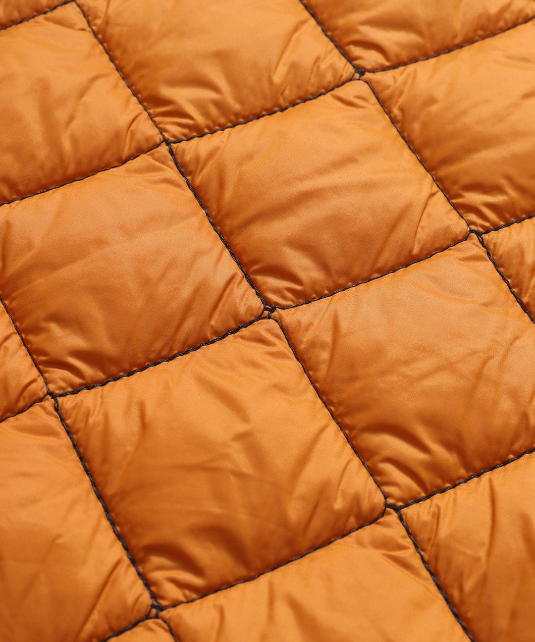 Close-up of the fabric texture of a women's quilted vest, durable and comfortable apparel.