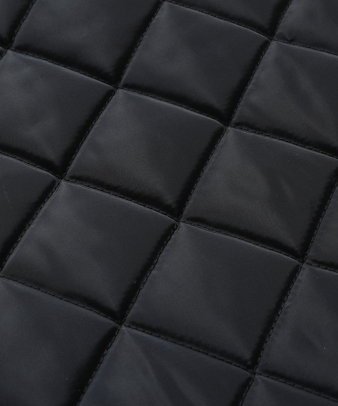 Detail of pockets on a women's quilted vest, functional and stylish outerwear feature.