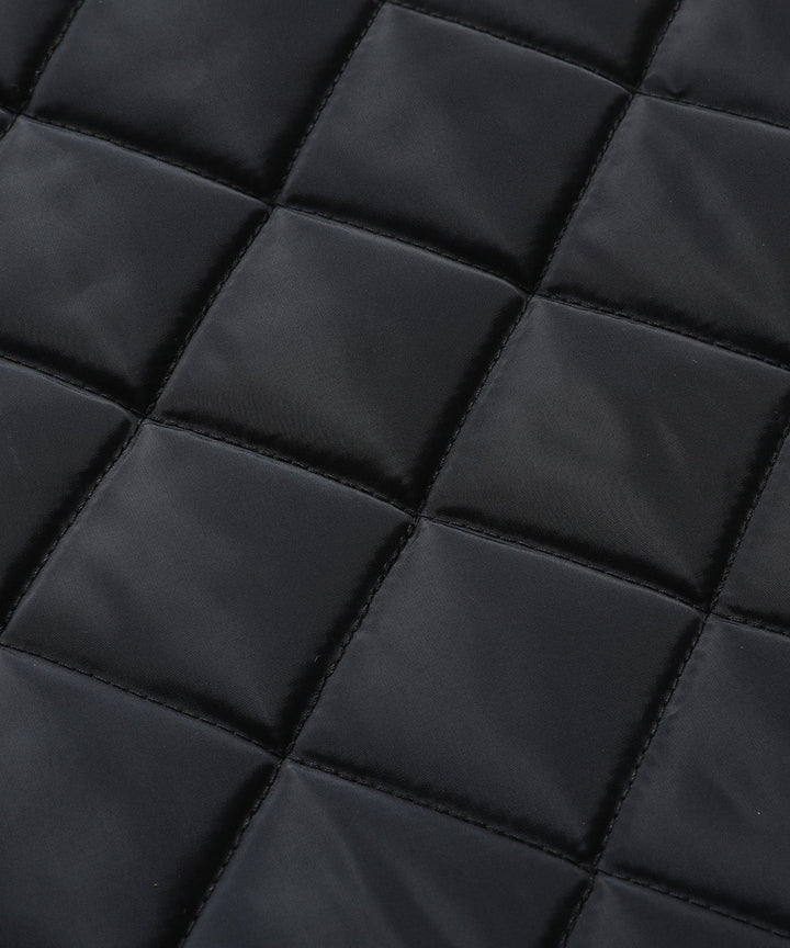 Detail of pockets on a women's quilted vest, functional and stylish outerwear feature.