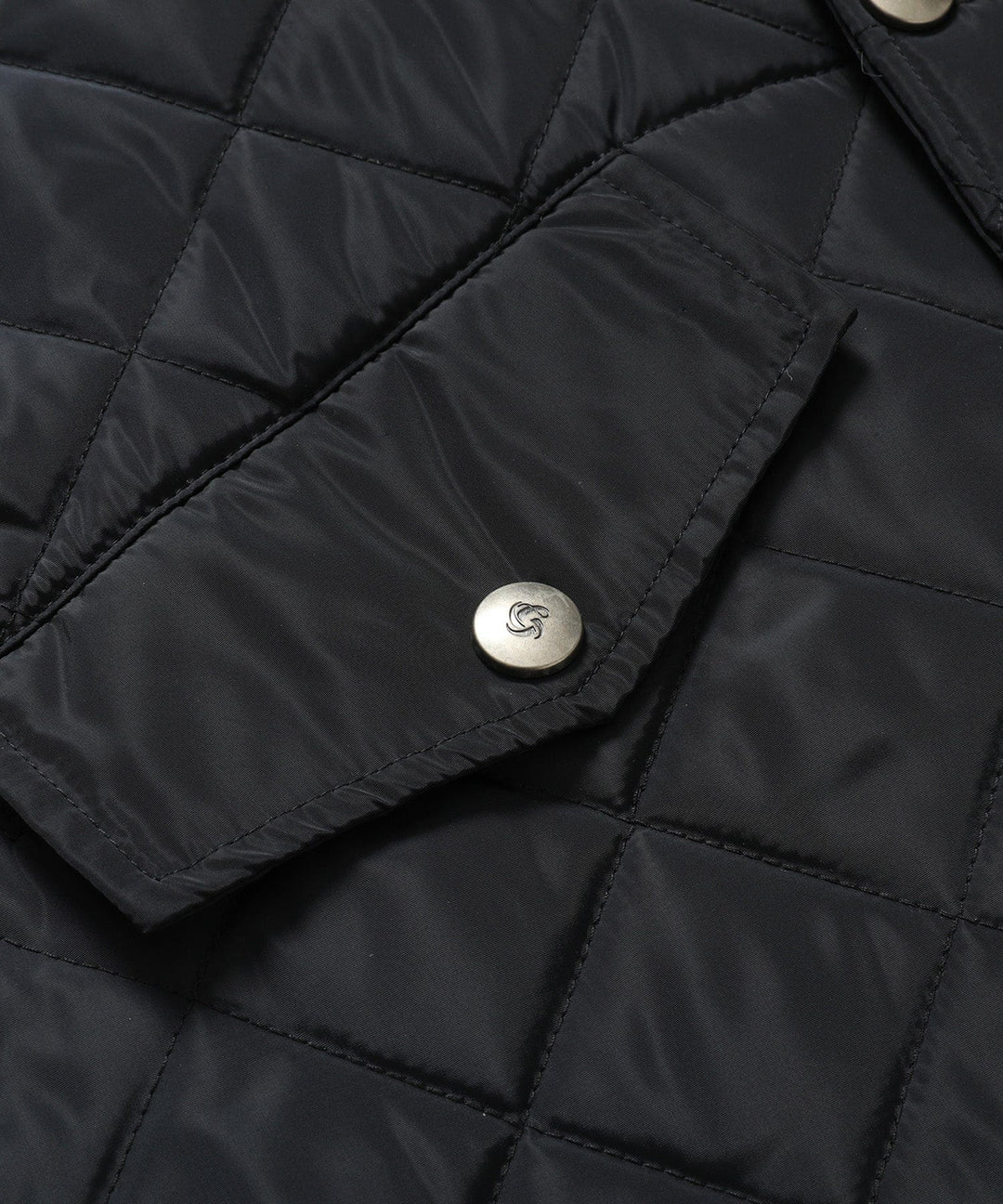 Women's longline quilted vest in black, styled with a long-sleeved top, versatile layering piece.