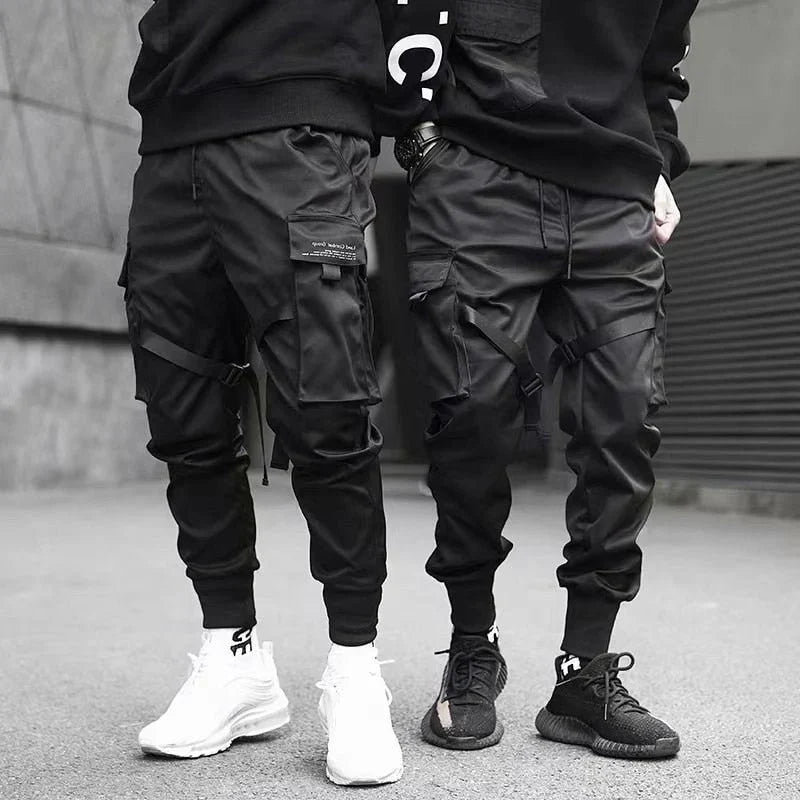Black multi-pocket cargo pants for men, featuring a relaxed fit for urban hip-hop fashion.