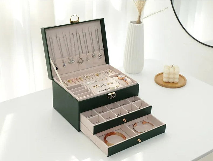 Open 3-tier jewelry box revealing compartments for rings, earrings, necklaces. Premium leather organizer.