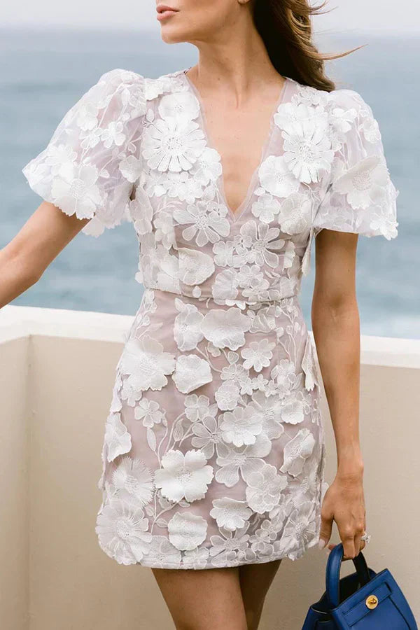 Stylish women's floral mini dress. Features short sleeves & a flared pastel print, perfect for party or casual summer wear.