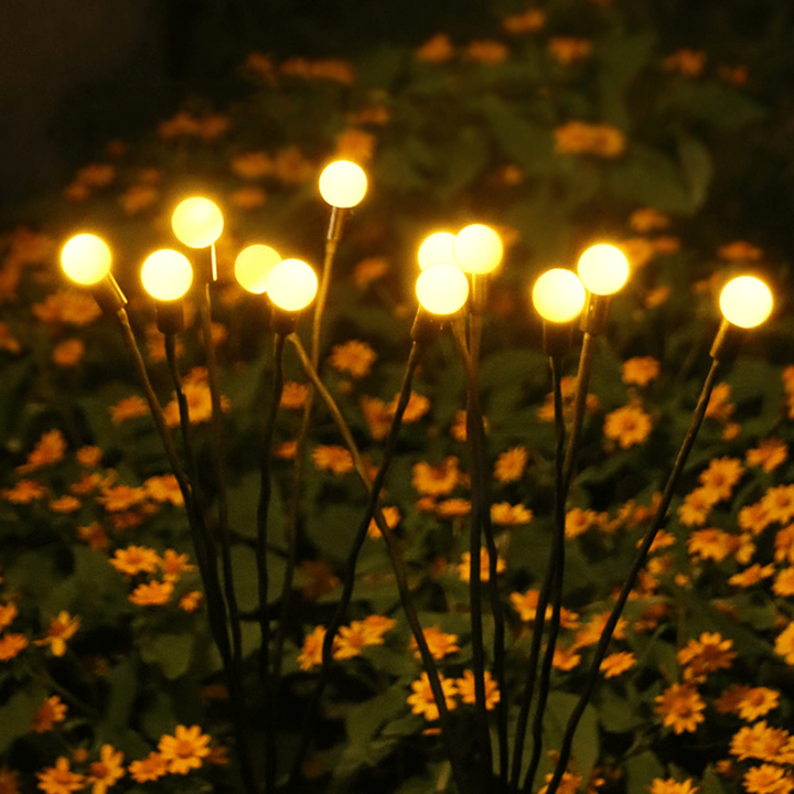 "Outdoor solar firefly garden lights with glowing LED bulbs on tall stakes, IP65 waterproof for enchanting yard decor."