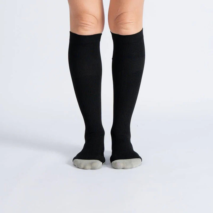 Pair of black and white unisex gentle compression socks for daily wear and improved circulation