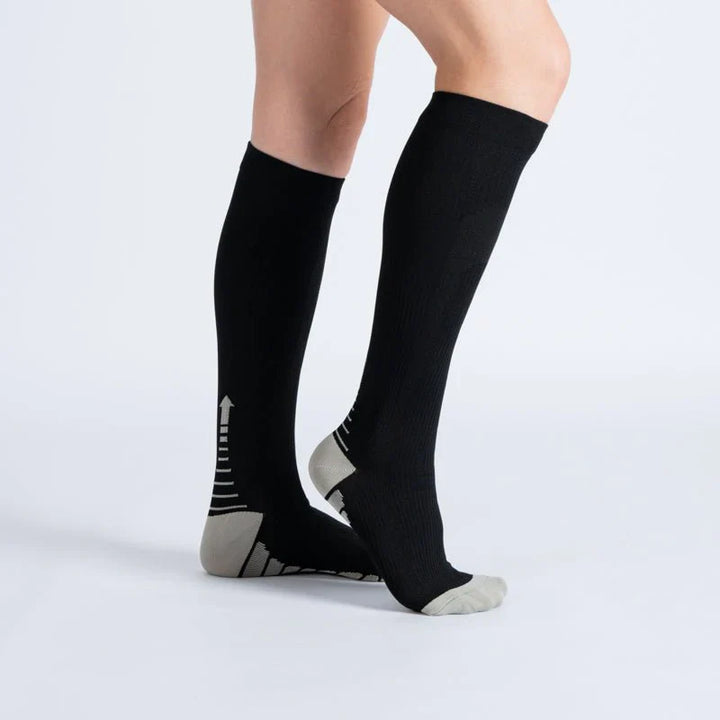 Close-up of black and white athletic compression socks, ideal for comfort and support