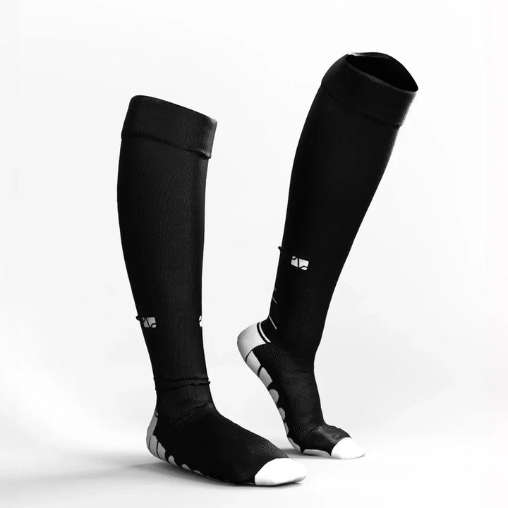 Detailed view of practical black & white compression socks, enhancing circulation and comfort