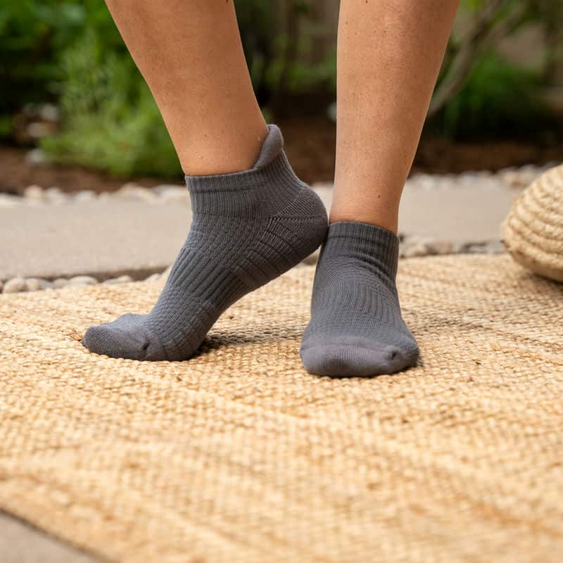 Unisex ankle compression socks on a white background, emphasizing their athletic design and relief properties.