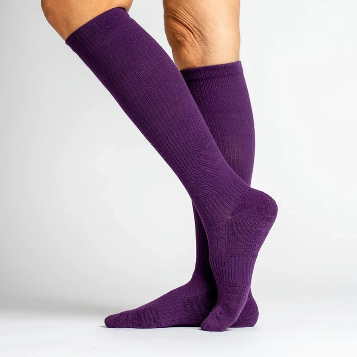 Unisex support socks in royal purple, designed to aid circulation and reduce leg fatigue.