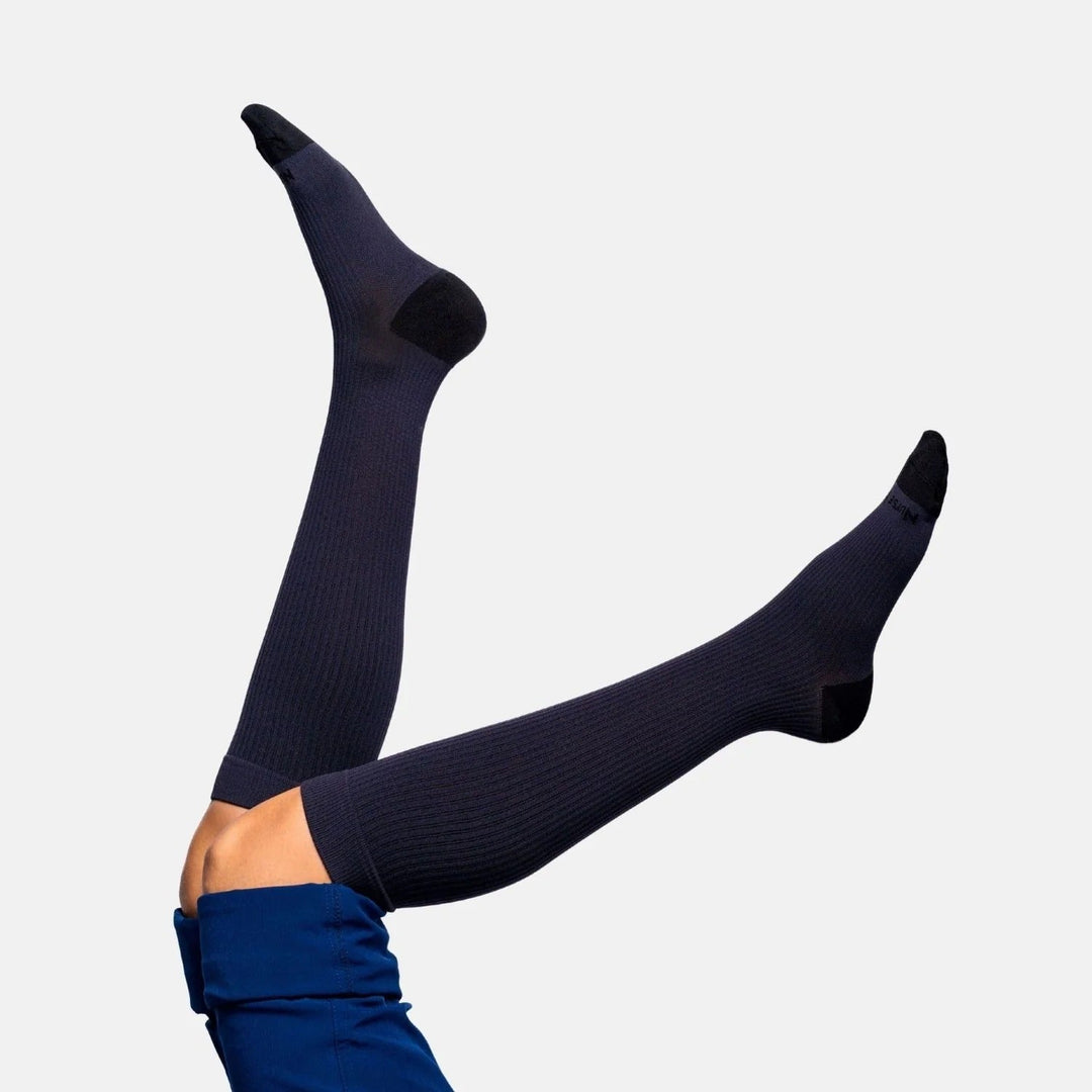 Unisex gentle compression socks, black, designed for leg comfort, suitable for travel or healthcare workers.