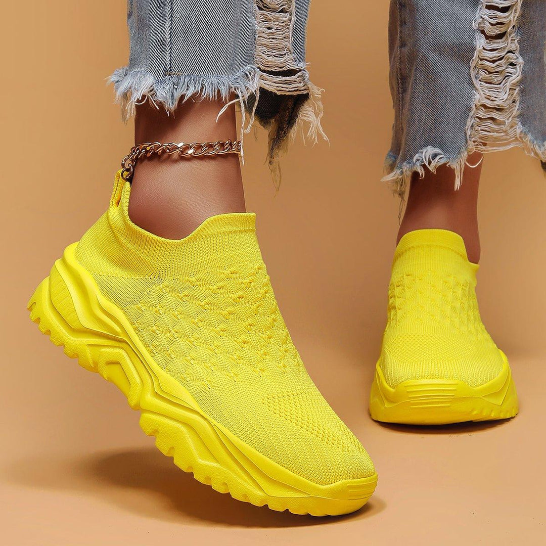 Stack of multiple yellow Unisex Ortho Cloud Slip-On Shoes, representing versatile comfort footwear
