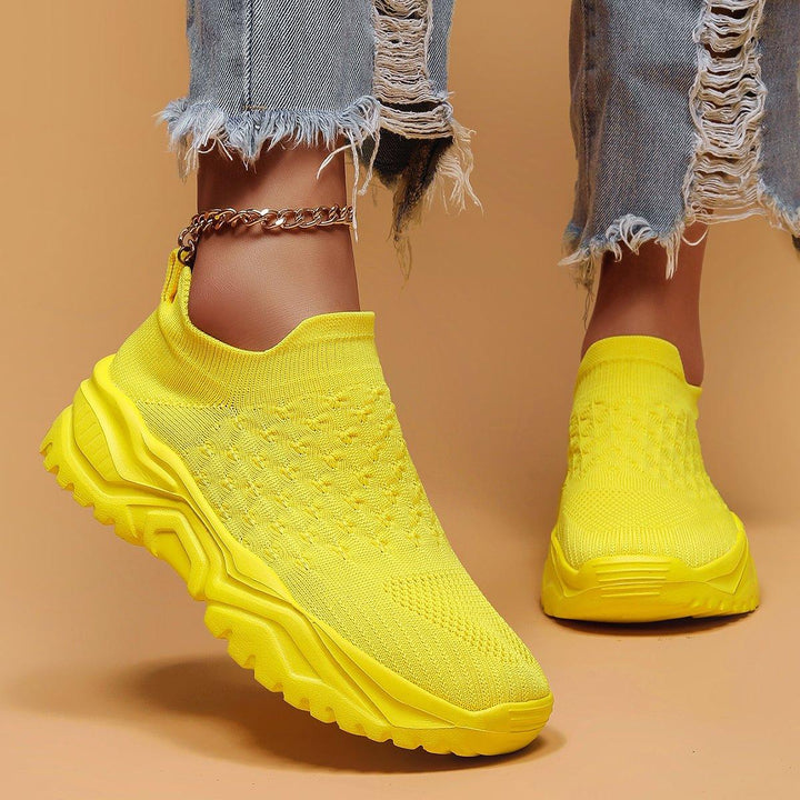 Stack of multiple yellow Unisex Ortho Cloud Slip-On Shoes, representing versatile comfort footwear