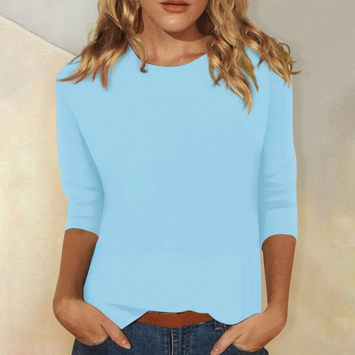 Comfortable women's casual 3/4 sleeve top in white, with a stylish round neck and relaxed fit.