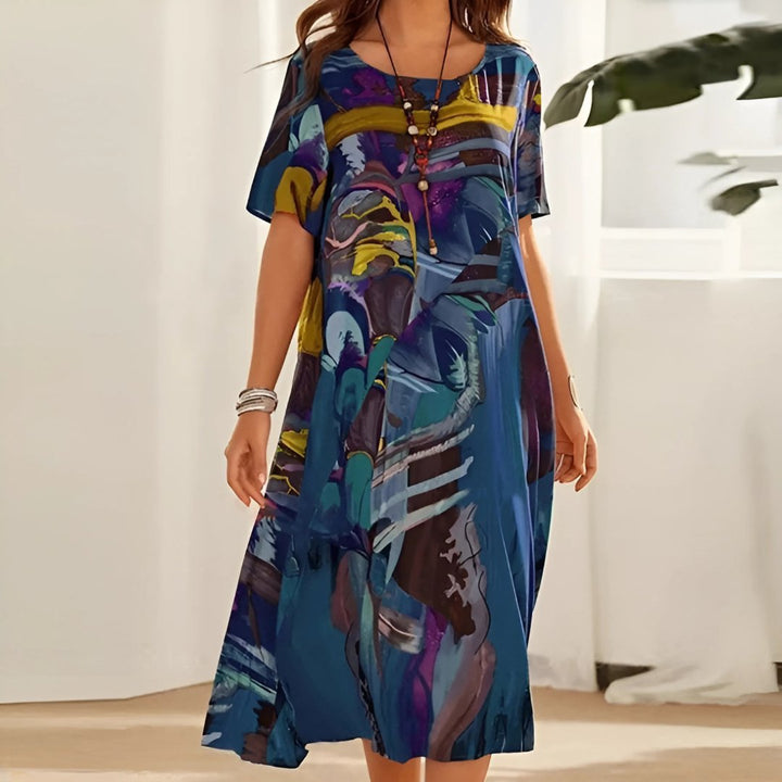 Plus size women's abstract print maxi dress with short sleeves, designed for a comfortable, flowy fit.