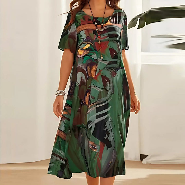 Stylish short sleeve plus size maxi dress featuring a vibrant abstract print, perfect for casual summer wear.