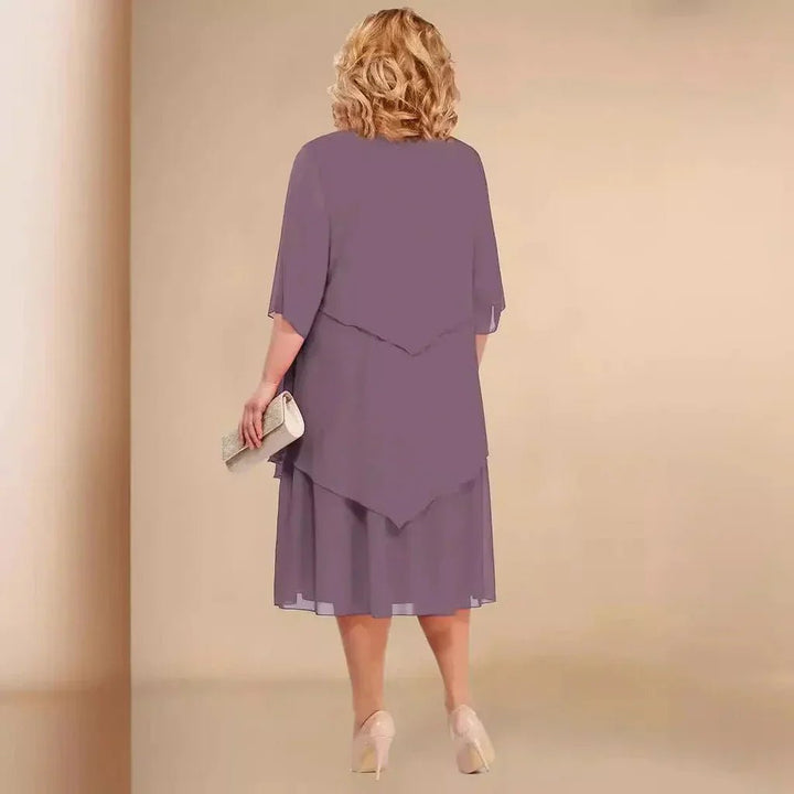 Plus size women's knee-length dress featuring an elegant layered asymmetrical chiffon design, formal attire.