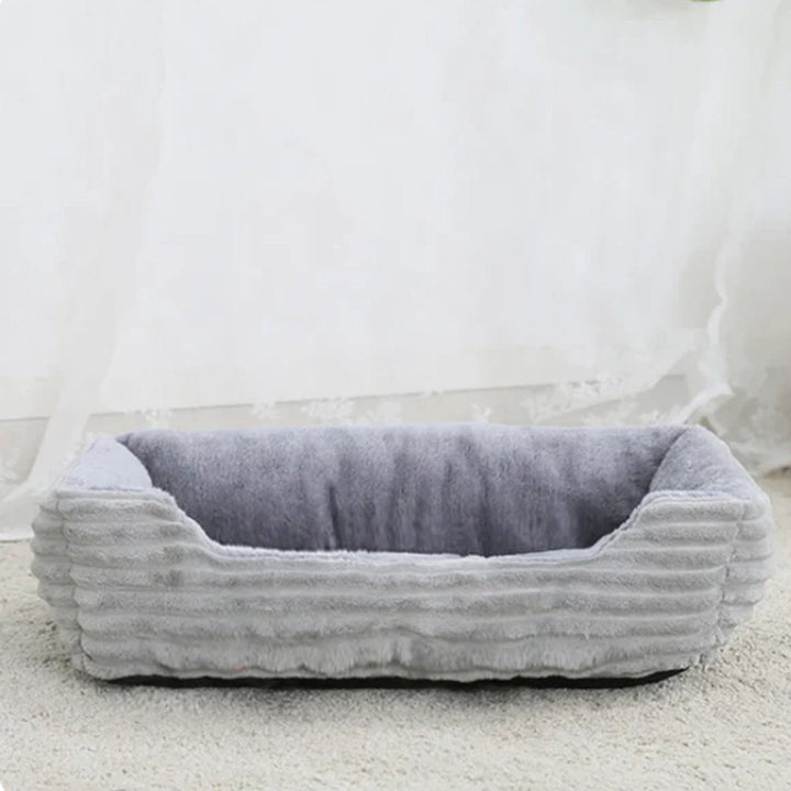 Ultimate comfort plush dog bed. Soft, washable pet bed with non-slip base for easy care.