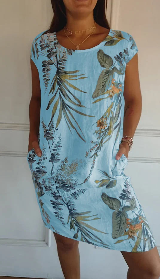 Detailed print on a women's casual round neck dress. Knee-length, flowy, and perfect for summer elegance.