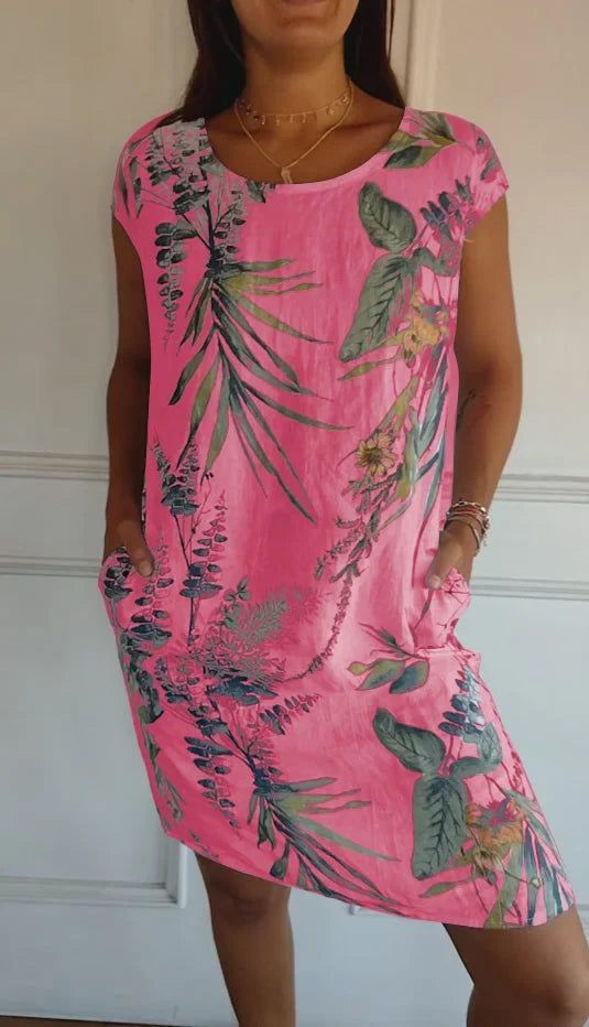 Women's summer printed round neck dress in an effortless flowy style. Perfect knee-length casual elegance.